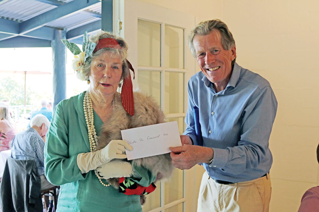 Nigel Waistell presents Delma McCrea  with a raffle prize
