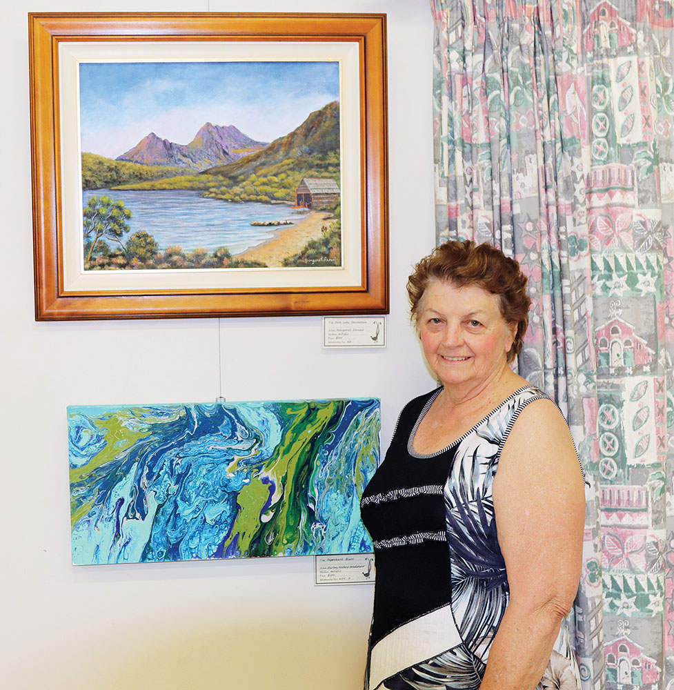 Margaret Dennis with her paintings