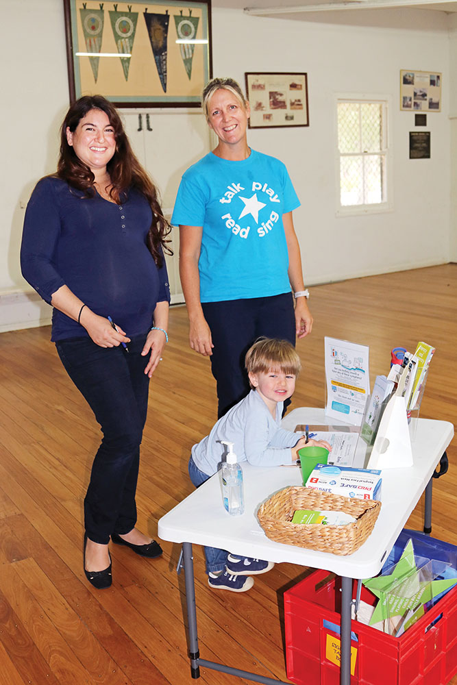 Mum Tal and Heidi from First Five Forever watch as Gabriel  ‘signs into’ the First Five Forever Rhymetime session