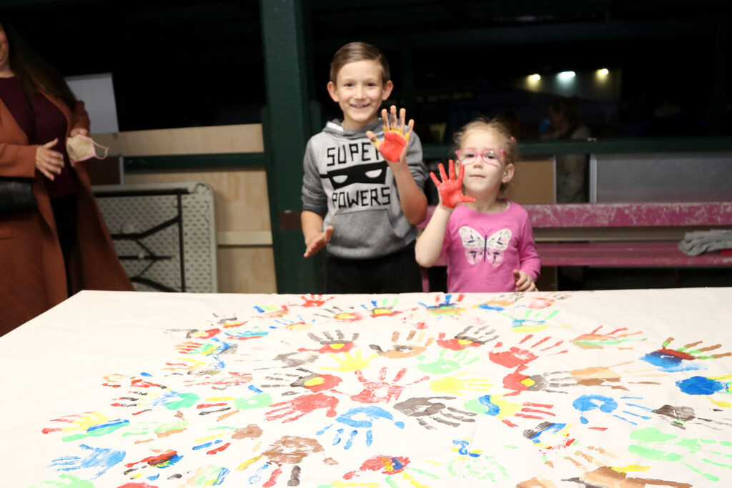 Students and families painted the Community Hand Print Banner