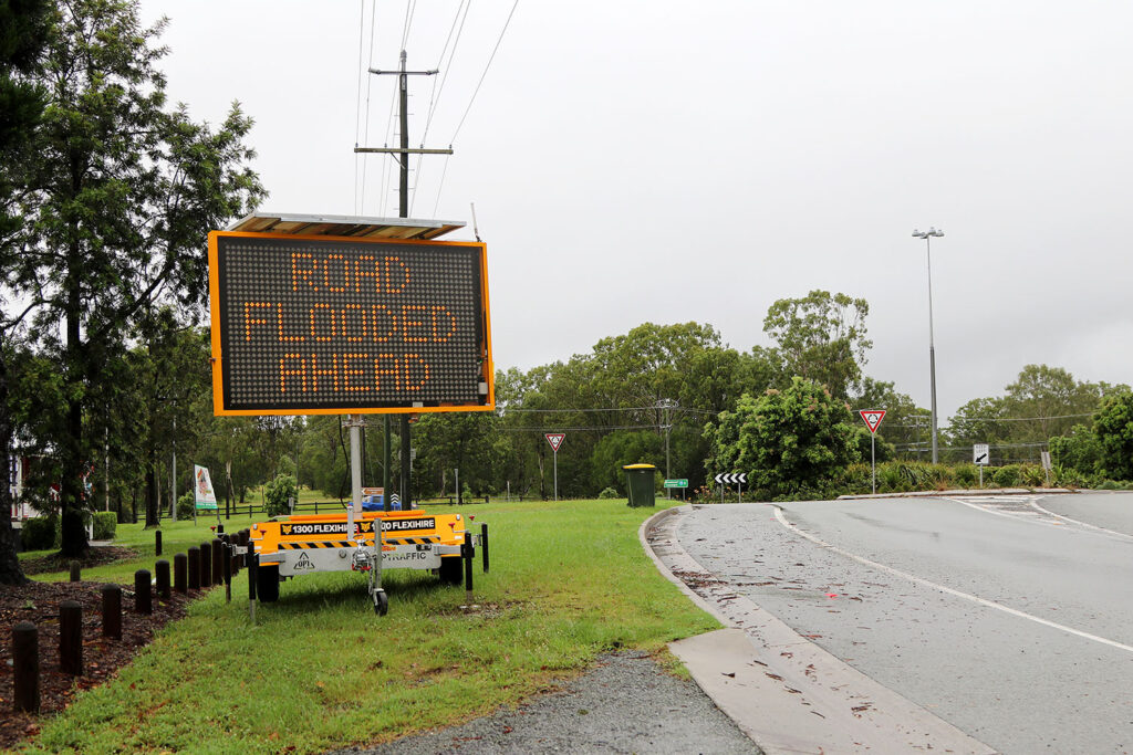 Road Flooded Sign At Roundabout
