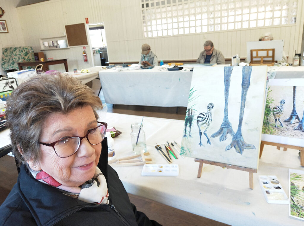 Arlene Greening with her painting of an Emu Family