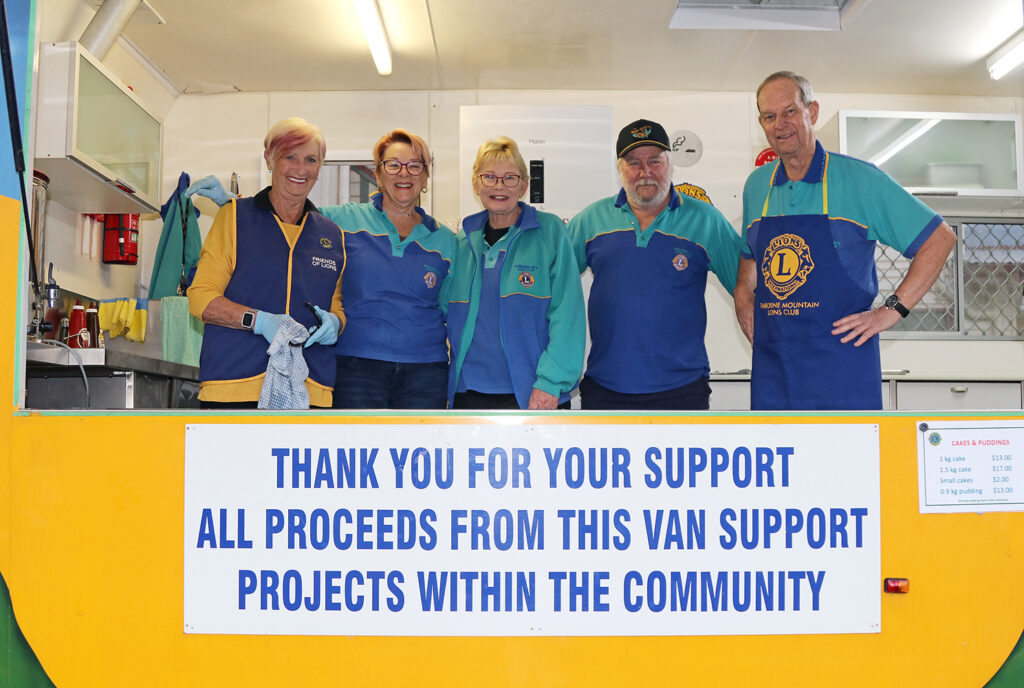 Members of the Tamborine Mountain Lions Club: Elley Payne, Marie Hofmeier, Vanessa Bull, Roger Baker, & John Hammond cooking sausages