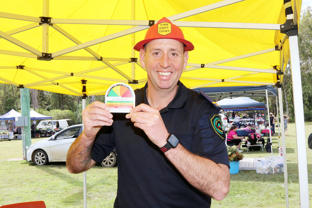 Firefighter Dan Roberts (with ‘Fire Dept Chief’ helmet) showing new fire danger rating system